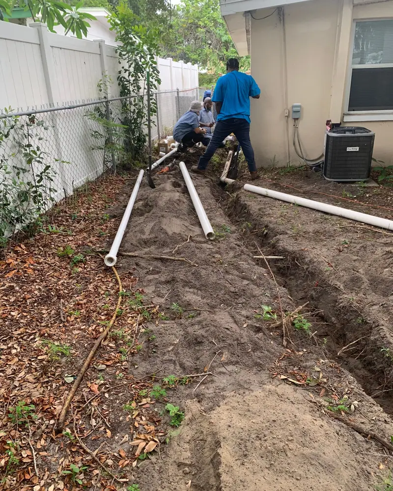 Crew trenching a yard line